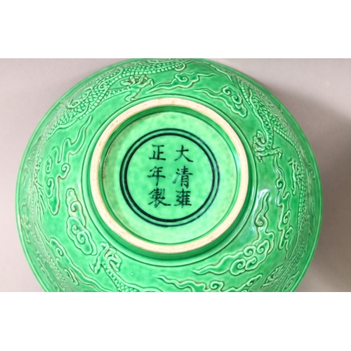 383 - A PAIR OF CHINESE GREEN GROUND MOULDED DRAGON BOWLS, 16cm diameter.