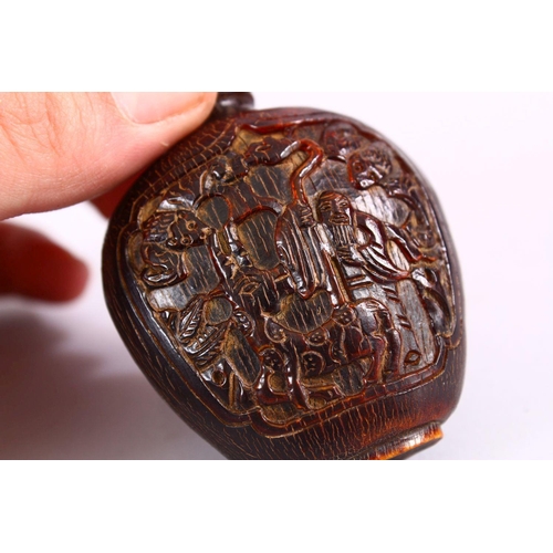 392 - A 19TH CENTURY CHINESE CARVED HORN SNUFF BOTTLE, carved with scenes of an immortal with deer, in lan... 