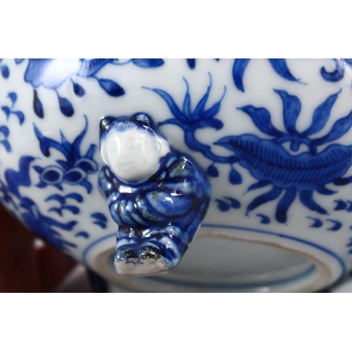 394 - A JAPANESE MEIJI PERIOD BLUE & WHITE TRIPOD BOWL, decorated with an interior scene of a village, the... 