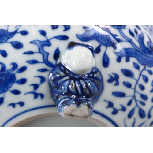 394 - A JAPANESE MEIJI PERIOD BLUE & WHITE TRIPOD BOWL, decorated with an interior scene of a village, the... 