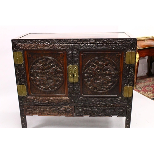 395 - A LOVELY 19TH CENTURY CHINESE HARDWOOD / HONGMU CARVED DRAGON TWO-DOOR CABINET, the door panels carv... 