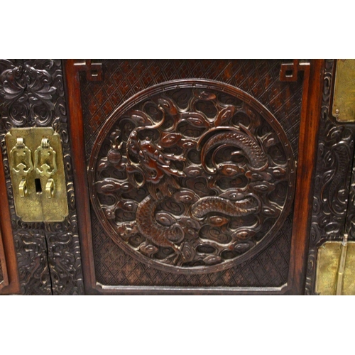 395 - A LOVELY 19TH CENTURY CHINESE HARDWOOD / HONGMU CARVED DRAGON TWO-DOOR CABINET, the door panels carv... 