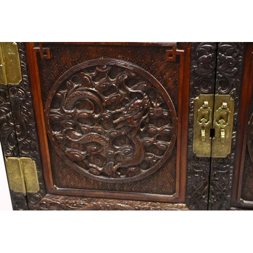 395 - A LOVELY 19TH CENTURY CHINESE HARDWOOD / HONGMU CARVED DRAGON TWO-DOOR CABINET, the door panels carv... 