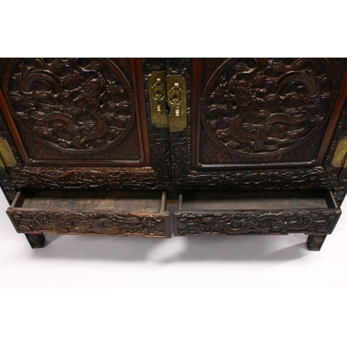 395 - A LOVELY 19TH CENTURY CHINESE HARDWOOD / HONGMU CARVED DRAGON TWO-DOOR CABINET, the door panels carv... 