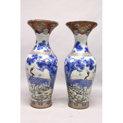 398 - A LARGE PAIR OF JAPANESE MEIJI PERIOD BLUE AND WHITE PORCELAIN IMARI VASES, the body of the vases de... 