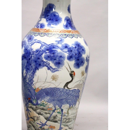 398 - A LARGE PAIR OF JAPANESE MEIJI PERIOD BLUE AND WHITE PORCELAIN IMARI VASES, the body of the vases de... 