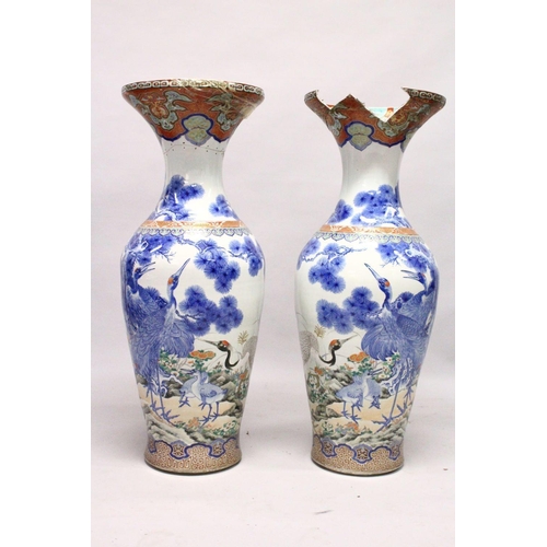 398 - A LARGE PAIR OF JAPANESE MEIJI PERIOD BLUE AND WHITE PORCELAIN IMARI VASES, the body of the vases de... 