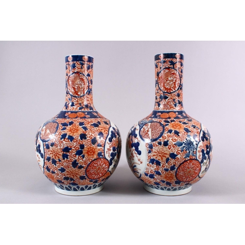 4 - A PAIR OF JAPANESE MEIJI PERIOD IMARI PORCELAIN BOTTLE VASES, decorated with panels of the three tre... 