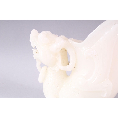 404 - A 20TH CENTURY CHINESE CARVED WHITE JADE LIBATION CUP OF A LION DOG, 14cm high.