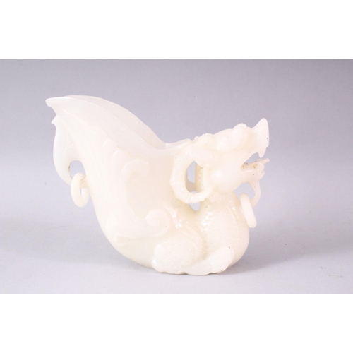 404 - A 20TH CENTURY CHINESE CARVED WHITE JADE LIBATION CUP OF A LION DOG, 14cm high.