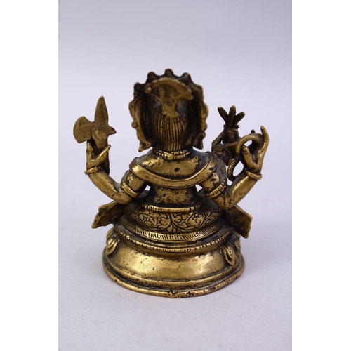 411 - A SMALL 19TH / 20TH CENTURY INDIAN BRONZE FIGURE OF GANESH, in a seated position holding multiple ob... 