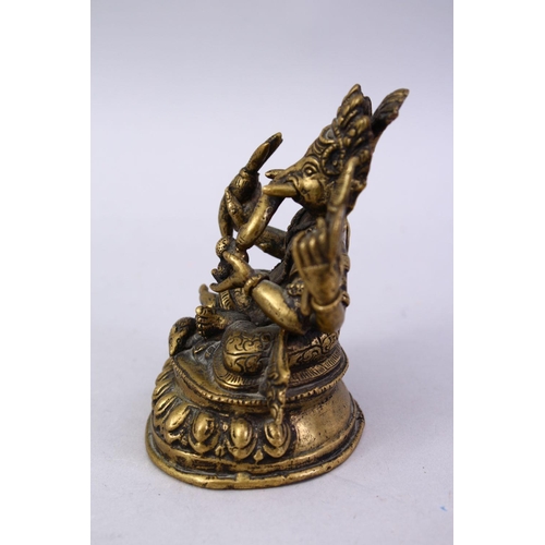 411 - A SMALL 19TH / 20TH CENTURY INDIAN BRONZE FIGURE OF GANESH, in a seated position holding multiple ob... 