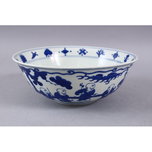 423 - A GOOD CHINESE MING STYLE BLUE & WHITE PORCELAIN BOWL, decorated with scenes of boys playing in  lan... 