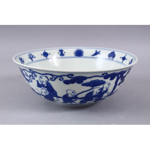 423 - A GOOD CHINESE MING STYLE BLUE & WHITE PORCELAIN BOWL, decorated with scenes of boys playing in  lan... 