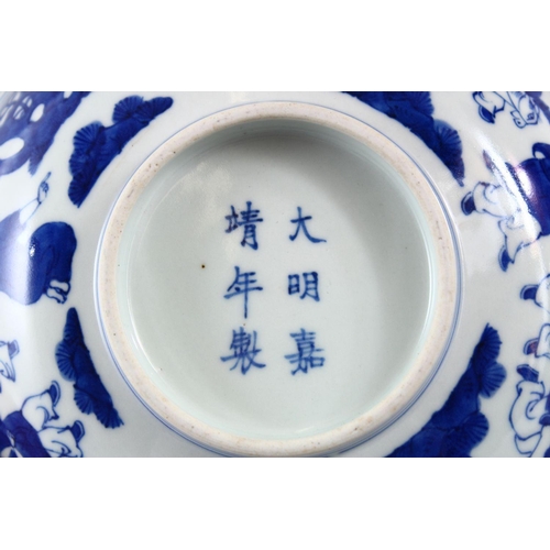 423 - A GOOD CHINESE MING STYLE BLUE & WHITE PORCELAIN BOWL, decorated with scenes of boys playing in  lan... 