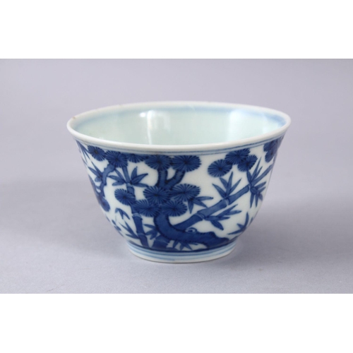 424 - A GOOD CHINIESE BLUE & WHITE MING STYLE PORCELAIN BOWL, decorated with pine trees and bamboo, the ba... 