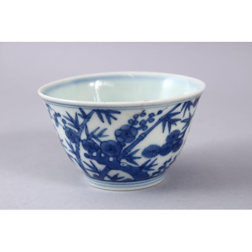 424 - A GOOD CHINIESE BLUE & WHITE MING STYLE PORCELAIN BOWL, decorated with pine trees and bamboo, the ba... 