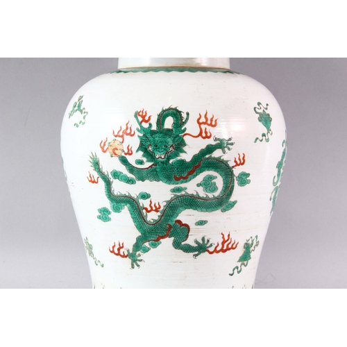 427 - A LATE 19TH / EARLY 20TH CENTURY FAMILLE VERTE TEMPLE JAR AND COVER, painted with dragons and symbol... 