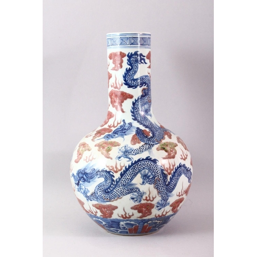 429 - A LARGE UNDERGLAZED BLUE AND COPPER RED DRAGON VASE, painted with dragons amongst clouds, six charac... 