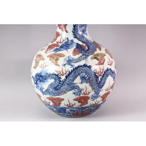 429 - A LARGE UNDERGLAZED BLUE AND COPPER RED DRAGON VASE, painted with dragons amongst clouds, six charac... 