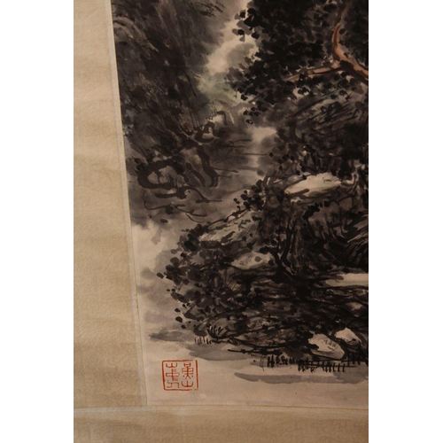 438 - A 20TH CENTURY CHINESE SCROLL PAINTING, depicting a mountainous landscape, image 112cm x 42cm.