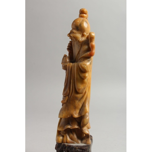 477 - A GOOD 19TH / 20TH CENTURY CHINESE CARVED SOAPSTONE FIGURE OF SHOU LAO, stood on a carved stone base... 