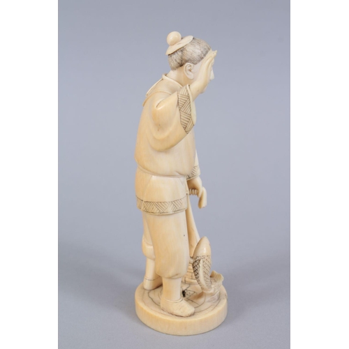 481 - A JAPANESE MEIJI PERIOD CARVED IVORY OKIMONO OF A FISHERMAN, the man stood holding his net, with one... 