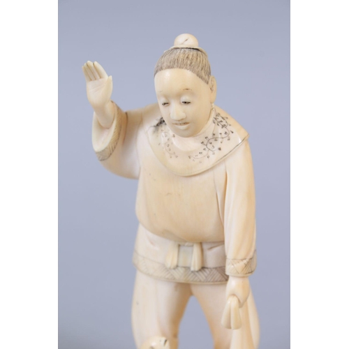 481 - A JAPANESE MEIJI PERIOD CARVED IVORY OKIMONO OF A FISHERMAN, the man stood holding his net, with one... 