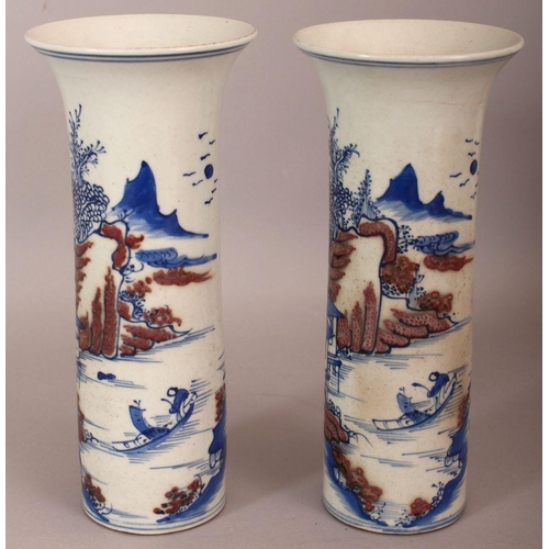 486 - A PAIR OF CHINESE COPPER-RED & UNDERGLAZE-BLUE CYLINDRICAL PORCELAIN VASES, each decorated with a ri... 