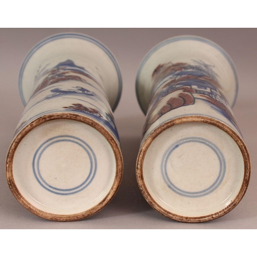 486 - A PAIR OF CHINESE COPPER-RED & UNDERGLAZE-BLUE CYLINDRICAL PORCELAIN VASES, each decorated with a ri... 