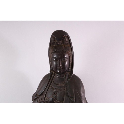 490 - A LARGE 19TH / 20TH CENTURY CHINESE CARVED HARDWOOD FIGURE OF GUANYIN, stood upon a lotus base, hold... 