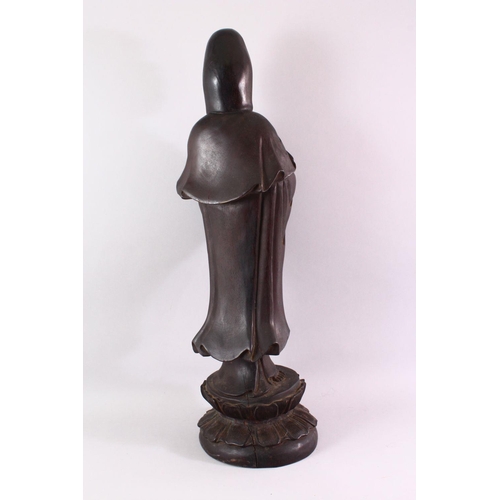 490 - A LARGE 19TH / 20TH CENTURY CHINESE CARVED HARDWOOD FIGURE OF GUANYIN, stood upon a lotus base, hold... 