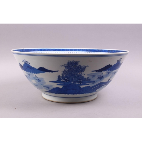 494 - A LARGE CHINESE BLUE & WHITE PORCELAIN BASIN, decorated with native views of a landscapes both sides... 