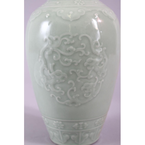 503 - A CHINESE CELADON PORCELAIN CARVED VASE, decorated with borders of Ruyi with roundel of chiilong, th... 