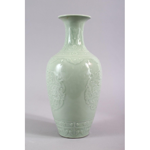 503 - A CHINESE CELADON PORCELAIN CARVED VASE, decorated with borders of Ruyi with roundel of chiilong, th... 