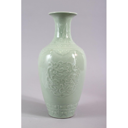 503 - A CHINESE CELADON PORCELAIN CARVED VASE, decorated with borders of Ruyi with roundel of chiilong, th... 