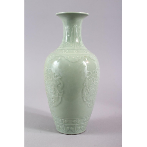 503 - A CHINESE CELADON PORCELAIN CARVED VASE, decorated with borders of Ruyi with roundel of chiilong, th... 