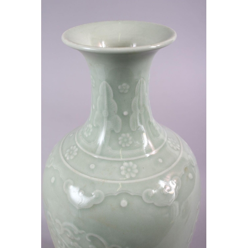 503 - A CHINESE CELADON PORCELAIN CARVED VASE, decorated with borders of Ruyi with roundel of chiilong, th... 