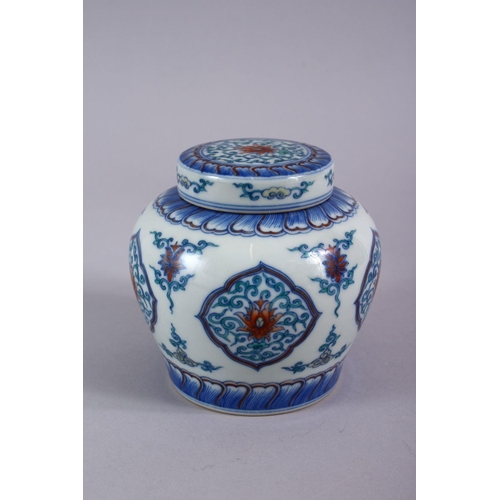 508 - A GOOD CHINESE DOUCAI PORCELAIN GINGER JAR AND COVER, the body with panels of formal scrolling lotus... 