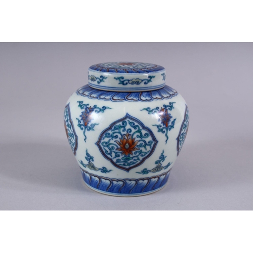 508 - A GOOD CHINESE DOUCAI PORCELAIN GINGER JAR AND COVER, the body with panels of formal scrolling lotus... 