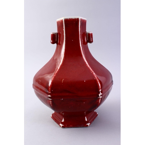 509 - A GOOD CHINESE COPPER RED HEXAGONAL PORCELAIN VASE, the body with ribbed sections with monochrome ed... 