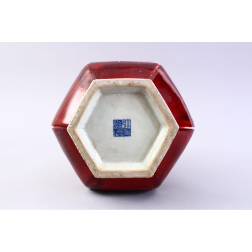 509 - A GOOD CHINESE COPPER RED HEXAGONAL PORCELAIN VASE, the body with ribbed sections with monochrome ed... 