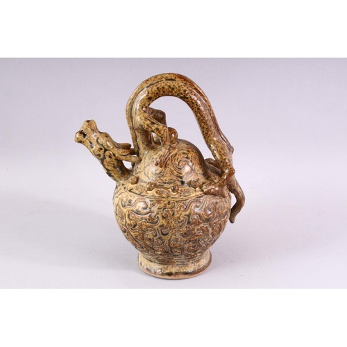 511 - AN UNUSUAL TREACLE GLAZED POTTERY WINE EWER, with dragon handle and spout, 23cm high.