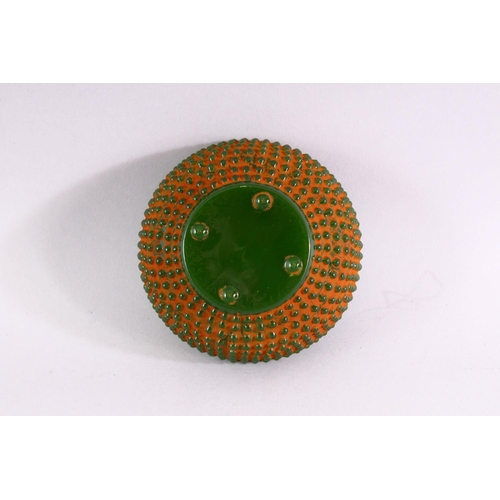 514 - A GREEN JADITE CIRCULAR BOWL with beaded decoration all over, 11.5cm diameter.