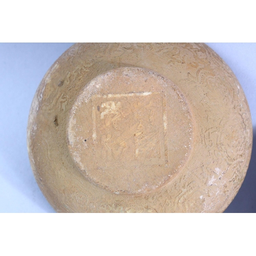 515 - A SMALL CHINESE POTTERY BOWL AND STAND, with incised decoration, 11cm diameter.