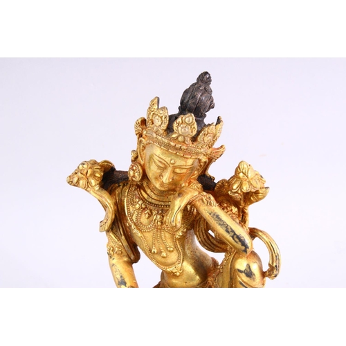 517 - A TIBETAN GILT BRONZE FIGURE OF A SEATED FEMALE DIETY, 20cm high.