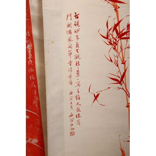 522 - TWO CHINESE RED INK SCROLL PICTURES, both depicting bamboo, both with a calligraphic script, images ... 