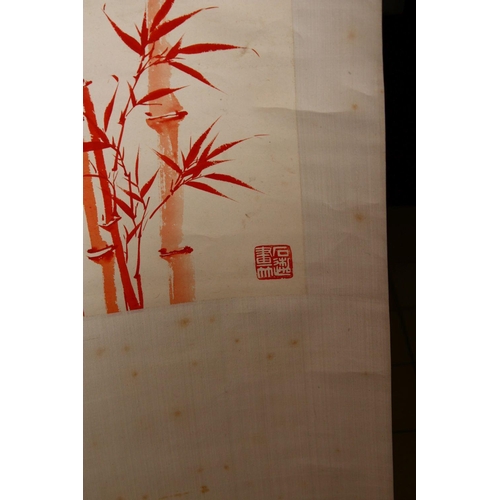 522 - TWO CHINESE RED INK SCROLL PICTURES, both depicting bamboo, both with a calligraphic script, images ... 