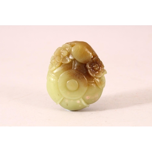 53 - A SMALL CELADON JADE BUD FORM BRUSHWASHER, the side decorated in high relief with a tengu and blosso... 