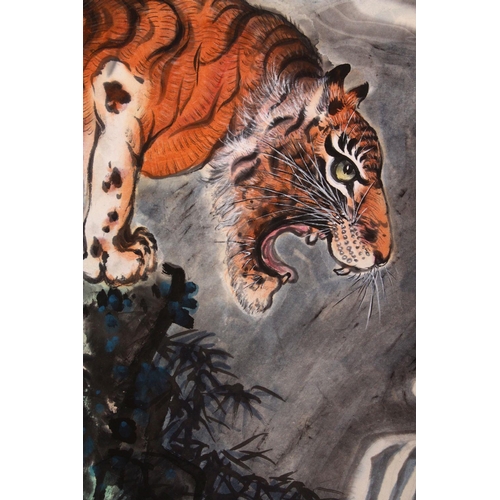 531 - A GOOD 20TH CENTURY CHINESE SCROLL PAINTING, depicting a growling tiger standing on a rocky outcrop ... 